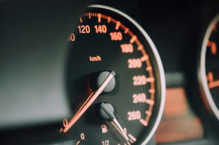 closeup photo of black analog speedometer
